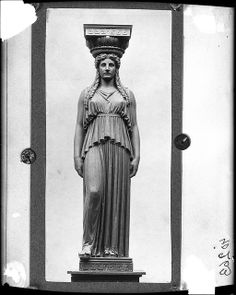 an old photo of a woman statue in black and white