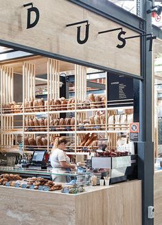 a bakery with lots of donuts on display behind the counter and in front of it