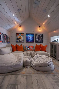 a living room filled with furniture and pictures on the wall