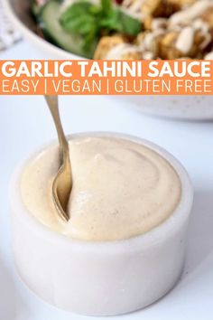 an image of a bowl of salad with dressing in it and the text garlic tahini sauce