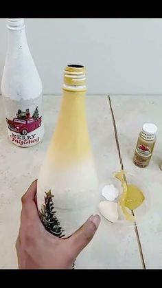 someone is painting the bottom of a wine bottle