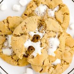 three cookies on a plate with marshmallows