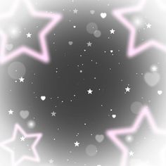 pink and white stars are in the air on a gray background with blurry lights