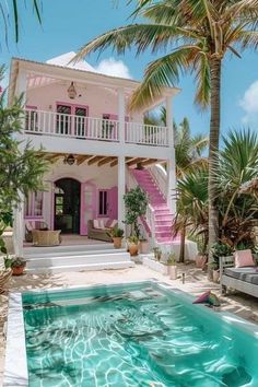 a pool in front of a pink house