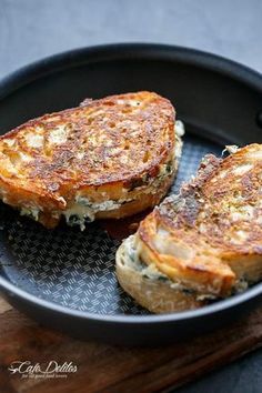 two pieces of toast sitting on top of a black plate