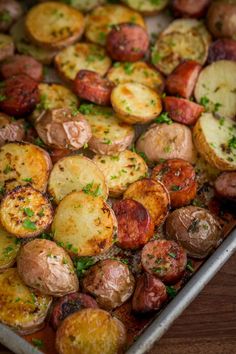 a pan filled with cooked potatoes and herbs