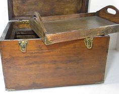 an old wooden box with two trays in it