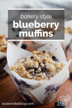 blueberry muffins in paper cups on a wooden table