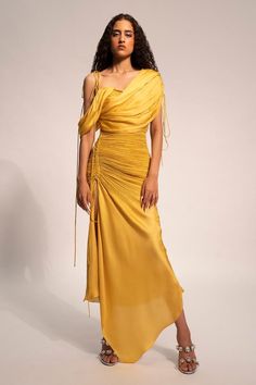 Yellow ray modal satin dress with overlap gathered draped panels, intricated pleated details and asymmetric hem.
Components: 1
Pattern: Plain
Neckline: Asymmetric Neck
Sleeve Type: Asymmetric Sleeves
Fabric: Modal Satin
Color: Yellow
Other Details: 
Gathered tie-up details
Side high slit
Occasion: Party - Aza Fashions Satin Drape Dress, Panelled Dress, Pleated Drapes, Drape Sleeves, Dyed Dress, Draped Dress, Dress For Women, Women Dresses, Elegant Dress