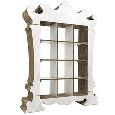 a white and gold book shelf with shelves