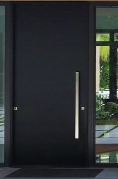 the front door is black and has glass panels on both sides, along with a metal handle