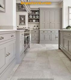 an image of a kitchen setting with grey cabinets and white counter tops on the walls