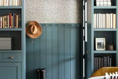 a room with blue bookcases and chess pieces on the table in front of it