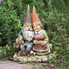 two garden gnomes sitting next to each other