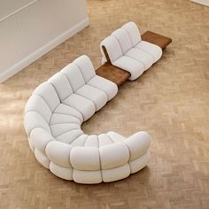 a white couch sitting on top of a hard wood floor