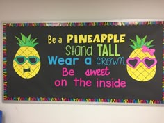 a bulletin board with two pineapples on it, and the words be a pineapple stand tall wear a crown be sweet on the inside