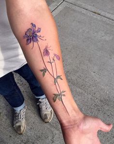 a person with a flower tattoo on their arm