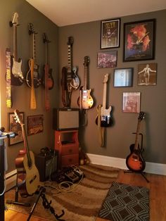 a room with guitars and other musical instruments on the wall, including an electric guitar