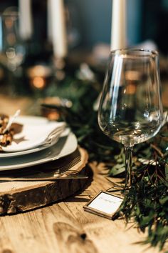 a table set with place settings and wine glasses