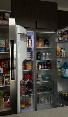 an open refrigerator with food and drinks in it