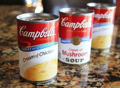 three cans of soup sitting on top of a counter