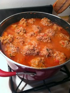 a large pot filled with meatballs on top of a stove