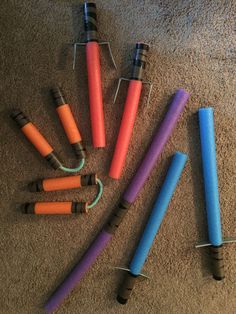 several different colored candles sitting on the floor