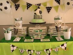 a green table topped with lots of cake and cupcakes on top of it