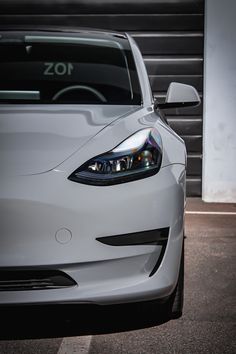 the front end of a white sports car