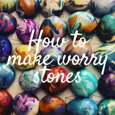 colorful marbles with the words how to make worry stones in white lettering on top