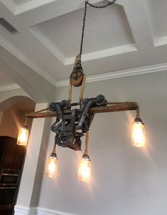 a chandelier hanging from the ceiling in a room with lights on either side