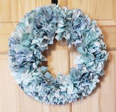 a close up of a wreath on a door with paper mache pieces around it