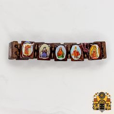 Introducing our exquisitely crafted Dark Brown Wood Bracelet adorned with iconic religious images, including Jesus Christ, Virgin Mary, Santo Niño, St. Jude, St. Joseph, St. Michael, and the revered Virgen de Guadalupe. This unique piece seamlessly blends spirituality with style, making it a perfect accessory for both men and women. Each bracelet features intricately detailed enamel images set on dark brown wooden rectangles, creating a stunning and harmonious design. The rich, deep hue of the wood adds a touch of natural elegance, enhancing the symbolic representation of faith and connection to the divine. The elastic band ensures a comfortable and secure fit for everyone, making it a versatile accessory suitable for all wrist sizes. Whether you're looking for a meaningful gift for a love Nut Bracelet, Mexican Gifts, Symbolic Representation, Grace To You, Religious Images, Wood Bracelet, Jesus Christus, St Jude, St Joseph