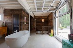 a large white bath tub sitting inside of a bathroom