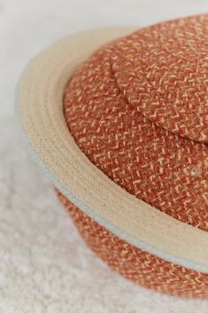 an orange and white hat sitting on top of a table