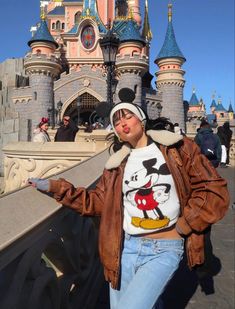 a woman standing in front of a castle