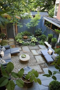 an outdoor living area with couches, tables and trees in the back yard is shown