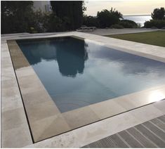 an empty swimming pool surrounded by wooden decking