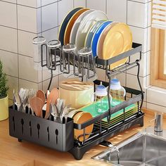 the dish rack is full of dishes and utensils