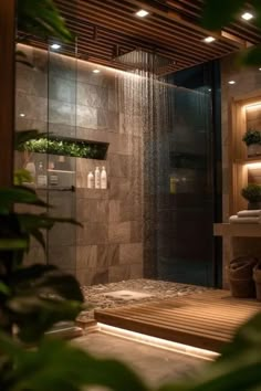 a bathroom with a shower, sink and plants in the shower headlight is on