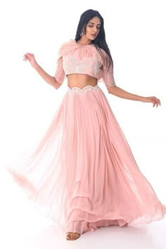 Blush pink scalloped and gathered lehenga with an attached cancan and 3D thread hand embroidered waistband. Comes with a padded tie-up crop top. Components: 2 Pattern: Hand embroidered Type Of Work: Thread Neckline: Round Sleeve Type: Draped Sleeves Fabric: Organza, Georgette Color: Pink Other Details:  Back tie-up detailing Blouse allowance : 4 inches Lehenga length : 45 inches Approx Product Weight (Kg) :  2 - 4 Occasion: Destination Wedding - Aza Fashions Lehenga Blouse Designs Crop Tops, Gathered Lehenga, Crop Top And Lehenga, Top And Lehenga, Padded Crop Top, Lehenga Crop Top, Crop Top Lehenga, Draped Sleeves, Carpet Outfits