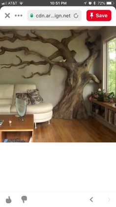 a living room with a tree painted on the wall