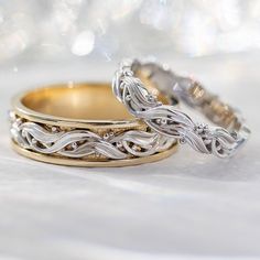 two wedding rings sitting on top of each other