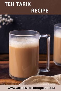 two mugs filled with coffee on top of a wooden table