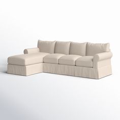 a white sectional couch sitting on top of a white floor