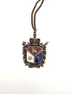 Vintage shield or Coat-of-Arms pendant with colorful enamel. Regal and stately piece is from the 1960's. The necklace is in good vintage condition. It measures about 14 inches and the pendant measures about 1 3/4 inches by 2 1/2 inches. Bundle and save. Free shipping on orders over $34.99  Find more necklaces at https://www.etsy.com/shop/FunandFancyVintage?ref=seller-platform-mcnav&section_id=36393637 Please visit our shop for more Fun and Fancy Jewelry!  www.etsy.com/shop/FunAndFancyVintage Bay City, Enamel Necklaces, Fancy Jewelry, 1960s Vintage, Pendant Necklaces, Favorite Jewelry, Jewelry Necklace Pendant, Vintage Jewelry, 1960s