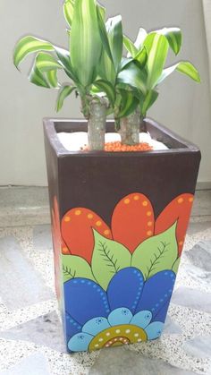 a potted plant sitting on top of a white floor next to a window sill