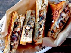 grilled cheese sandwiches with nuts and raisins in a basket