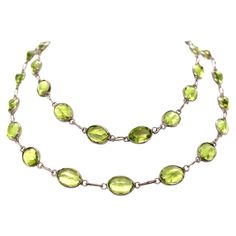 This elegant necklace is made of a single strand of 20 inches of alluring peridots set in 18K white gold. The unique green of the peridot is what makes this necklace so captivating. The peridot, also known as the stardust gem, is one that never fails to steal attention – the wearer of this necklace is sure to turn heads with this beautiful masterpiece. Luxury Gold Peridot Necklaces, Green Single Strand Necklace For Formal Occasions, Lime Green Peridot Necklace For May Birthstone, Green Briolette Necklace In Fine Jewelry Style, Green Briolette Necklace Fine Jewelry, Fine Jewelry Peridot Necklace For May Birthstone, Oval Peridot Jewelry For Formal Occasions, Green Peridot Gemstone Necklace, Green Oval Single Strand Jewelry