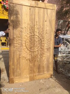 a man standing next to a large wooden door